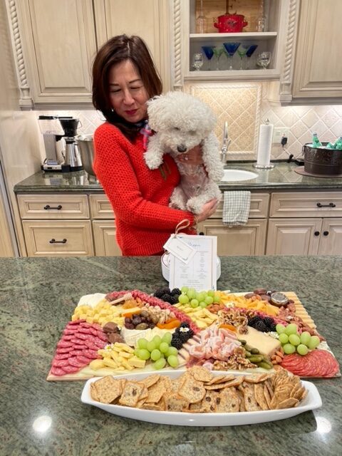 Rosa and dog and plate of food on counter