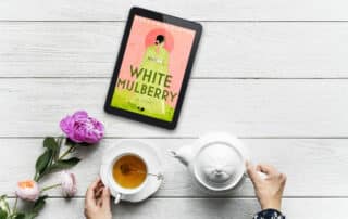 White Mulberry on a tablet with a cup of tea.