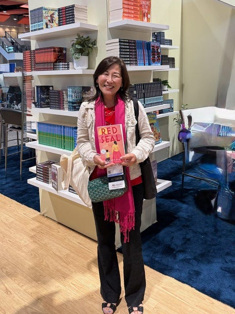 Rosa holding an advance copy of Red Seal
