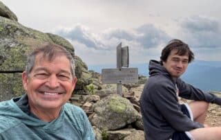 Father and son hiking in the mountains of Maine