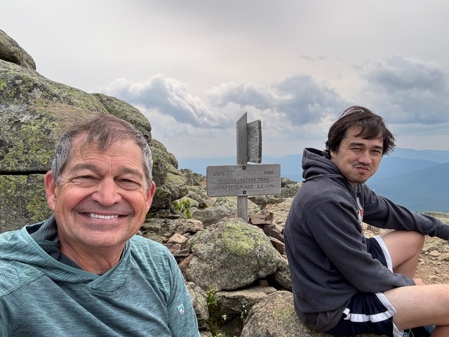 Father and son hiking in the mountains of Maine